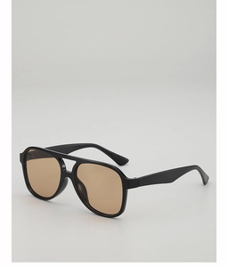 Macro view of double-bridge aviator frame with vintage tawny lenses and glossy black finish
