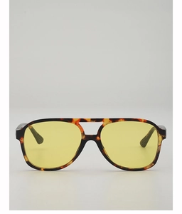 Detail of retro aviator sunglasses with yellow lenses and tortoise shell frames