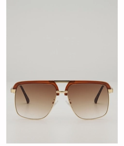 Detail of navigator sunglasses with gold metal frame and gradient brown lenses