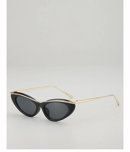 Close-up of retro cat-eye sunglasses with black frame and golden metal temples