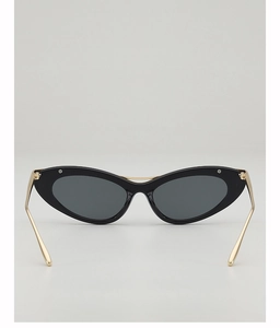 Detail of vintage cat-eye sunglasses with black frame and golden metal temples