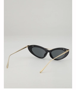 Detail view of retro cat eye sunglasses with black thick frames and slim gold metal temples