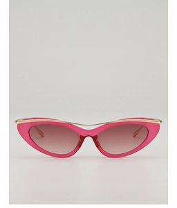 Detail view of pink cat-eye sunglasses with gold metal bar and gradient brown lenses