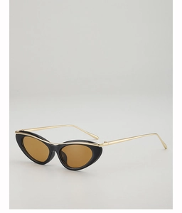 Cat eye sunglasses detail with black frame and golden metal brow bar design