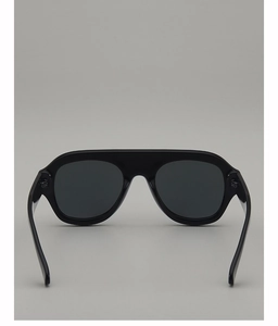 Detail view of glossy black aviator sunglasses with integrated nose pads and grey lenses