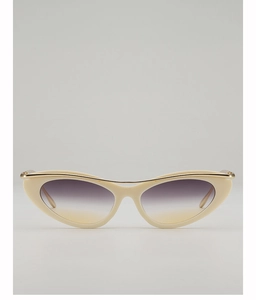 Detail of cream cat-eye sunglasses with gold metal top bar and purple gradient lenses