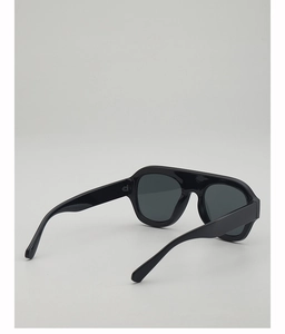 Side view of black pilot-style sunglasses featuring glossy frames and smoke lenses