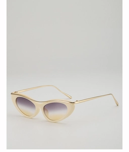 Detail view of cream cat-eye sunglasses with gradient lenses and gold metal accents