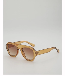 Detailed view of amber transparent pilot sunglasses with brown gradient lenses