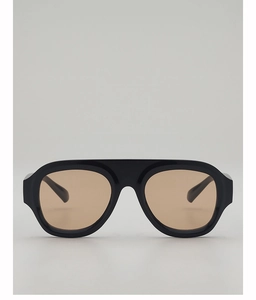 Close-up of retro oversized square sunglasses with black frames and gradient brown lenses