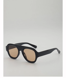Detailed side view of thick black acetate frame sunglasses with round brown lenses