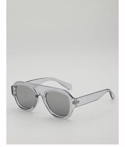 Detailed view of the transparent smoke grey resin frame and dark lenses of sun glasses
