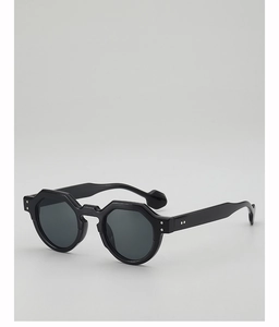 Detail of black geometric polygon sunglasses with thick acetate frame and silver rivets