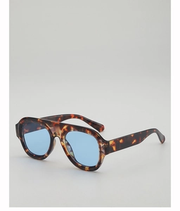 Detail of retro aviator sunglasses with tortoise frame and light blue lenses