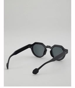 Detail view of bold black octagonal frame sunglasses with wide temples and dark lenses