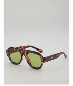Detail of retro tortoiseshell sunglasses frame with stylish light green lenses