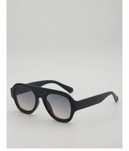 Close-up of black matte oversized aviator sunglasses with gradient blue-brown lenses