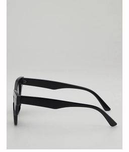 Side view detail showing the thick black frames and sleek temples of these oval sunglasses