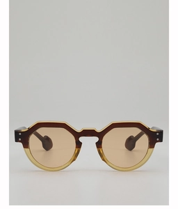 Close-up of retro round blue tortoiseshell sunglasses with dual-tone frame and silver rivets