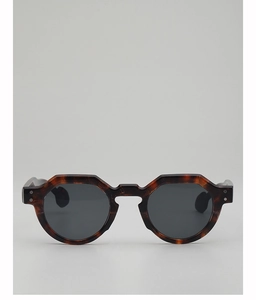 Detail of retro tortoiseshell octagonal frame sunglasses with dark grey lenses