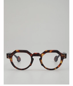Detail of round tortoiseshell glasses frame with geometric cut and metal rivets