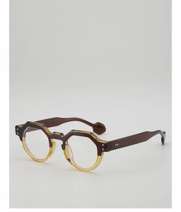 Detail of round tortoise sunglasses featuring dual-tone acetate frame and metal rivets