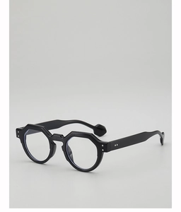 Detail of black polygonal eyewear frame with metallic rivets and retro temple tips