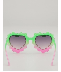 Detail of heart-shaped sunglasses featuring green-pink gradient and floral petal edges