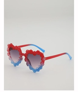 Detail of heart-shaped kids sunglasses with 3D gradient daisy floral decorations