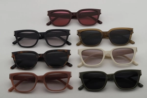 Flat lay of square sunglasses in seven colors with metal trim and smooth finish