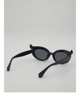 Detail view of the horn-shaped hinges and glossy black frame on these punk sunglasses