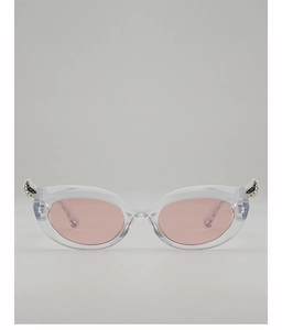 Detail of transparent cat-eye sunglasses with silver horn metal accents and pink lenses