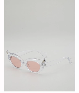 Detail of transparent creative sunglasses with pink lenses and silver devil horn accents