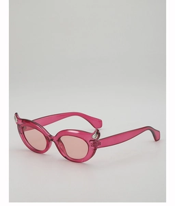 Detailed side view of pink cat-eye sunglasses with unique devil horn accents and silver studs