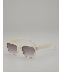 Detail of cream square sunglasses with thick frames and gradient lenses on grey background