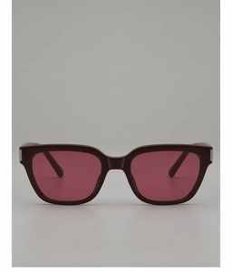 Detail of red-brown square frame sunglasses with pink lenses and silver hinges
