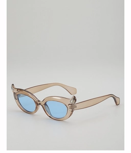 Detail of brown cat-eye frame with blue lenses and rhinestone-studded horn accents