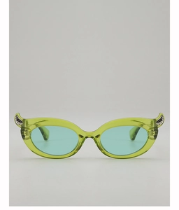Detail of horn-shaped translucent yellow-green sunglasses with light blue lenses