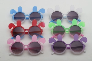 Detailed flat lay of six colorful bunny-ear shaped sunglasses for children party wear