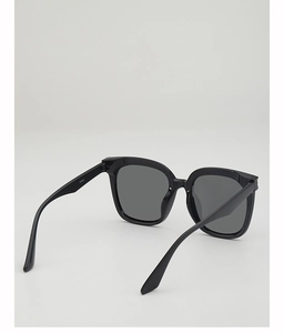 Detail shot of black sunglasses showing the inner hinge and A1083 model number