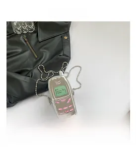 Retro cell phone shaped crossbody bag with silver shell and pink keypad detail