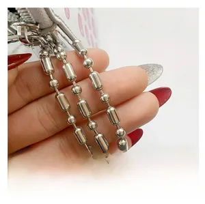 Detailed macro view of a silver metal ball chain shoulder strap for mini bags