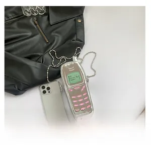 Detailed view of silver mirror PU mobile phone shaped crossbody bag with ball chain strap