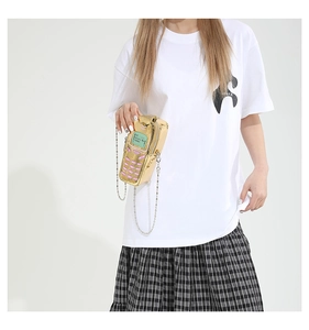 Close-up of retro mobile phone shaped crossbody bag in gold with silver chain