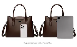 Size comparison of brown leather crossbody bag with iPhone and iPad in detail view