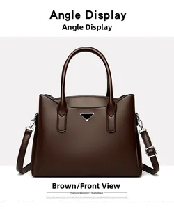 Front view of textured brown leather handbag with metal triangle logo and top handles