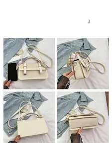 Detail view of cream canvas crossbody bag with decorative scarf and leather trim