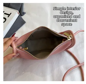 Detail view of pink crossbody bag interior with large capacity and smooth zipper