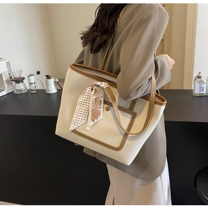Borsa tote bicolore alla moda con dettaglio sciarpa pied de poule in un caffè