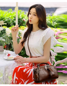 Brown Boston bag with checkered texture shown in an outdoor garden cafe lifestyle setting